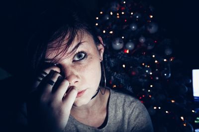 Portrait of young woman with christmas tree