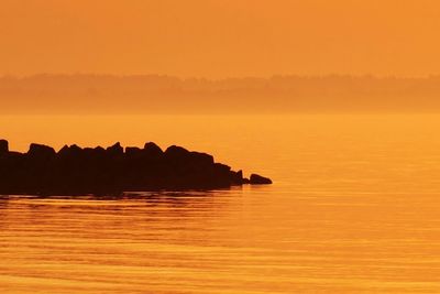 Scenic view of sea at sunset