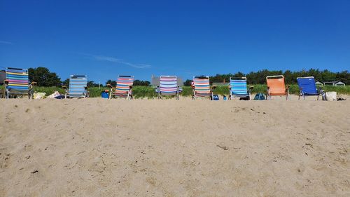 Built structures on beach against clear blue sky