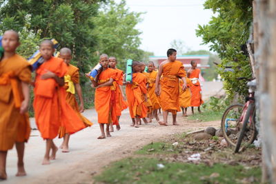 Rear view of people walking in temple