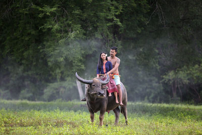 People riding horse on land