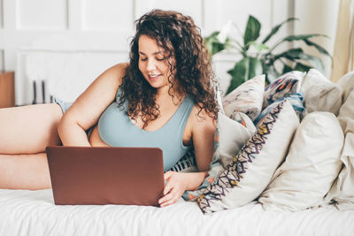 Young woman using laptop at home