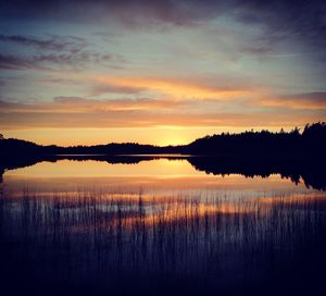 Scenic view of lake against romantic sky at sunset