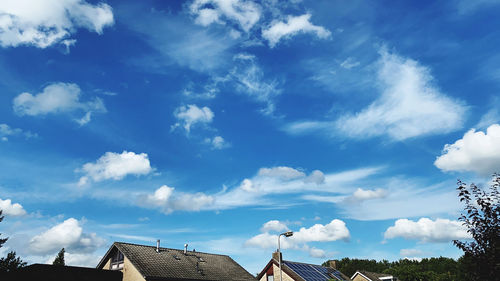 Low angle view of buildings against blue sky