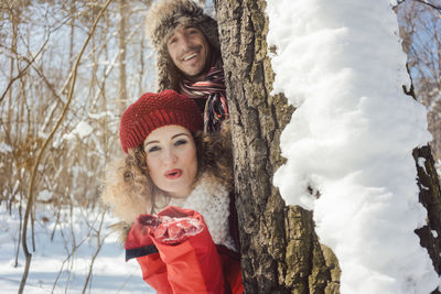 Portrait of smiling young woman in snow