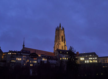 Low angle view of illuminated buildings against sky at dusk