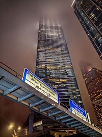 Low angle view of skyscrapers lit up at night