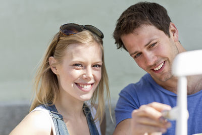 Smiling young couple painting, stockholm, sweden