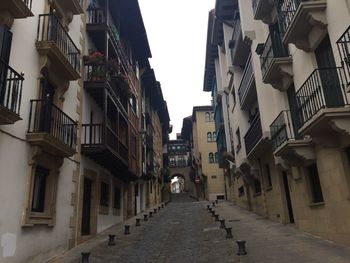 Empty lane amidst buildings