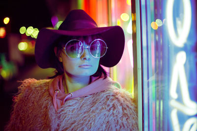 Woman wearing sunglasses while standing in city