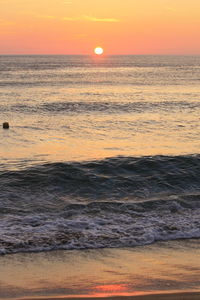Scenic view of sea against romantic sky at sunset