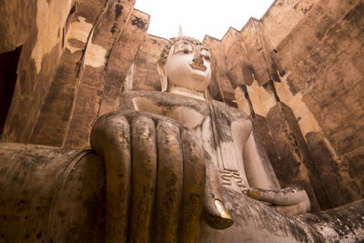 Sculpture of buddha statue outside building