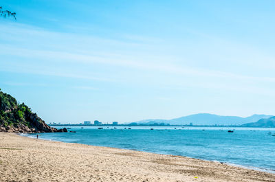 Scenic view of beach against blue sky