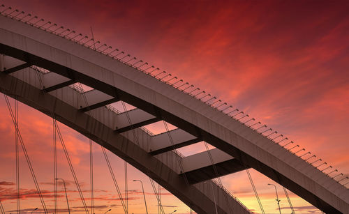 Low angle view of bridge against sky during sunset