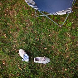 Low section of person relaxing on field