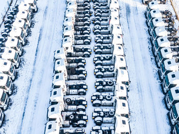 Aerial top view of new truck cars parking for sale stock lot row, dealer inventory import 