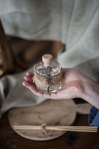 Close-up of man holding perfume bottle