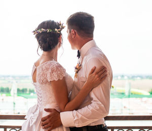 Side view of couple standing at beach