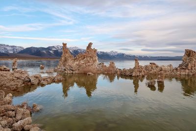 Scenic view of rocks in sea against sky