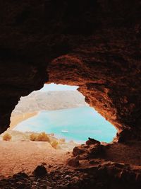 Scenic view of sea seen through cave