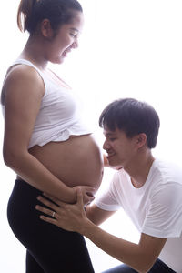 Side view of a woman touching head