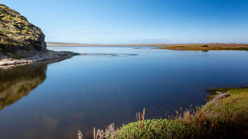 Scenic view of lake against clear blue sky