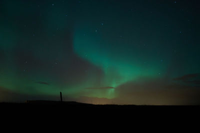 Low angle view of silhouette landscape against sky at night