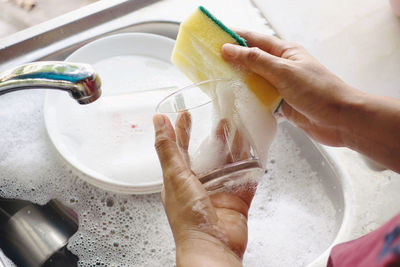 High angle view of hand holding water at home