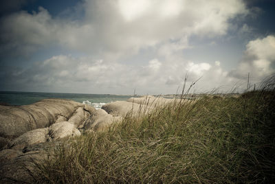 Scenic view of sea against cloudy sky