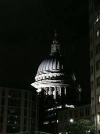 Low angle view of illuminated building against sky at night