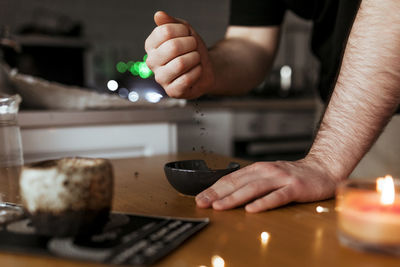 Midsection of man preparing food