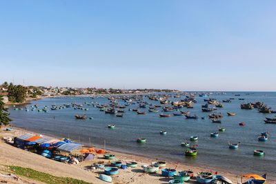 High angle view of people on beach against clear sky