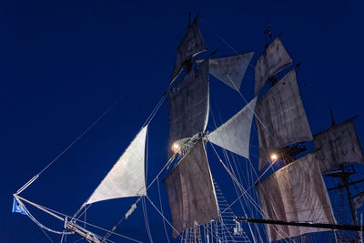 Low angle view of tall ship against clear sky at night