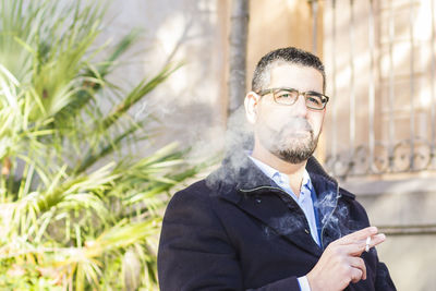 Man smoking cigarette outdoors