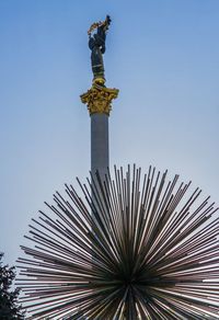 Low angle view of statue of building against sky