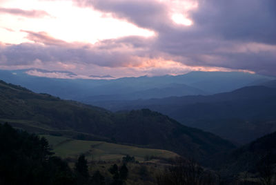 Scenic view of mountains against sky at sunset