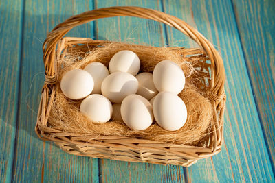 High angle view of eggs in basket on table