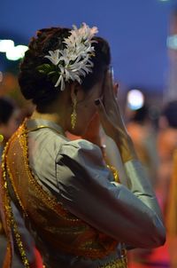 Rear view of woman wearing hat standing outdoors
