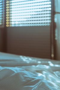 Close-up of curtain on bed at home