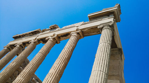 Low angle view of historical building against clear blue sky