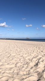 Scenic view of beach against blue sky