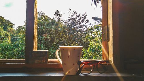 Empty chair and table against trees