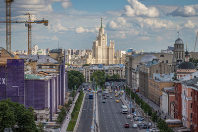 High angle view of city street against cloudy sky