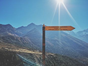 View of sign on mountain against blue sky