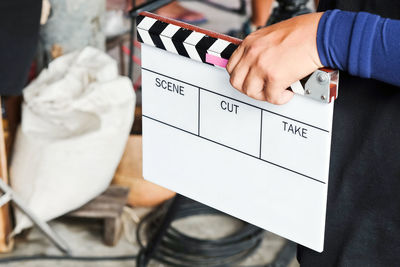 Close-up of person holding film slate