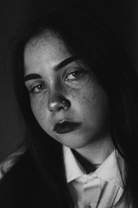 Close-up portrait of woman in darkroom