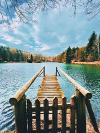 Pier over lake against sky