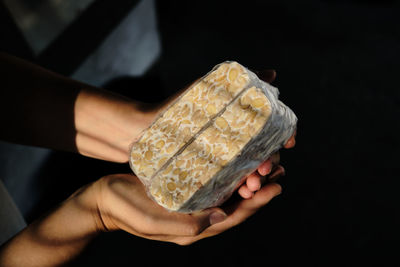 Cropped hand of person holding food