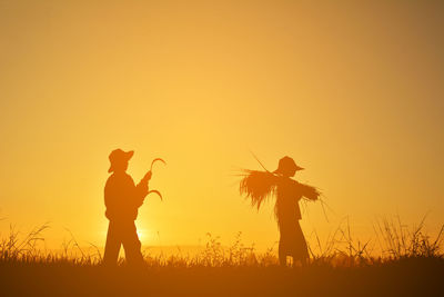 Silhouette of men playing at sunset