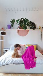 High angle view of dog sitting on bed